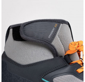 Robust outdoor shoe in gray with turquoise-orange accents, high shaft, and grippy treaded sole for secure footing.